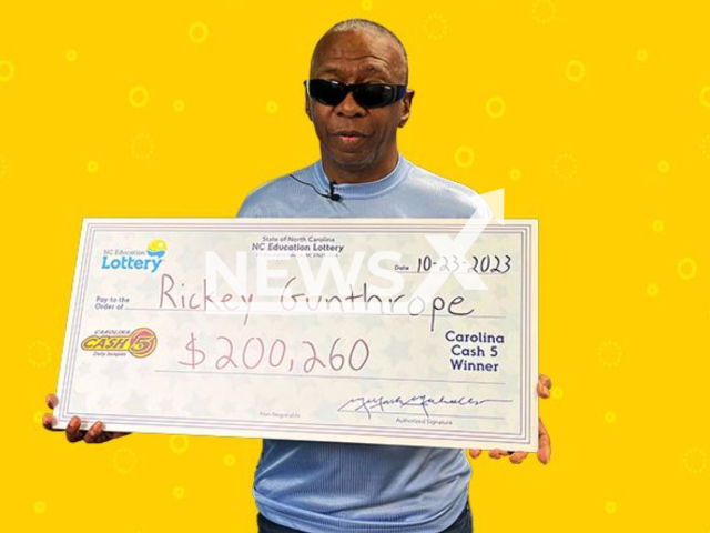 Rickey Gunthrope poses with his prize winning check. He won a USD 200,260 (GBP 164,671) Cash 5 jackpot and how he will buy his nephew a car that he promised with the money. Note: Licensed photo.  (NC Lottery/Newsflash)