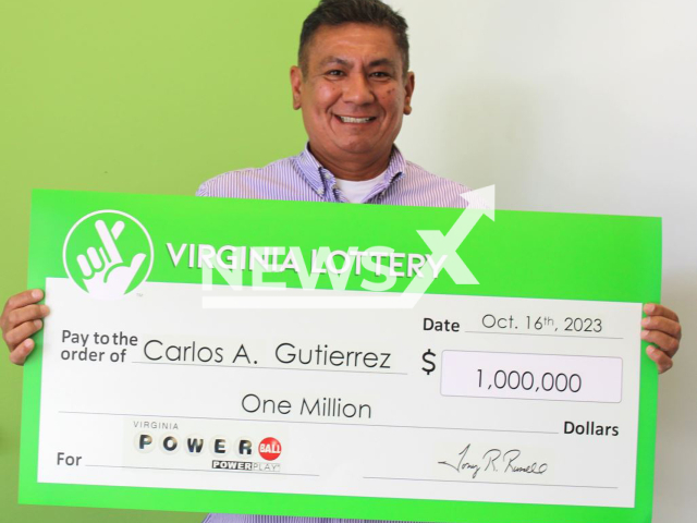 Carlos Gutierrez  poses with his prize wining check, undated.  He decided to buy a ticket for that night’s drawing as he waited for his chicken sandwich and coffee, before work.  Note: Licensed photo. (Virginia Lottery/Newsflash)