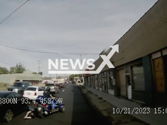 A motorcycle passenger  falls of the vehicle, in Hot Springs, Arkansas, USA,  on Saturday, Oct. 21, 2023. A bus driver stops just in time to not hit her, after the motorcycle driver  had to swerve into another lane to avoid a rear-end collision.
Note: Picture is screenshot from a video. (@cityofhotsprings/Newsflash)