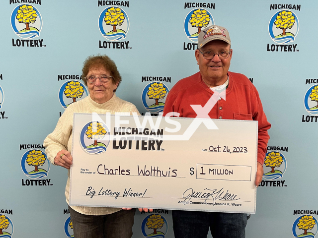 Charles Wolthuis (right) and his wife Jean Wolthuis (left) hold the $1 million check, undated. He bought his winning ticket at Purk’s, located at 875 East Lincoln in Ionia, Michigan. Note: Lottery photo. (Michigan Lottery/Newsflash)