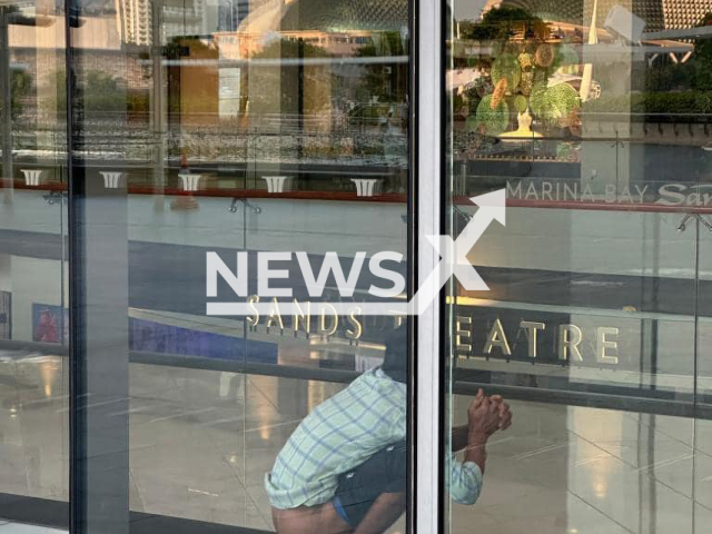 Photo shows a man defecating in view at Marina Bay Sands, undated. Marina Bay Sands is an integrated resort fronting Marina Bay in Singapore and a landmark of the city. Note: Picture is private (Newsflash)