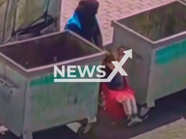 A mother was filmed swinging her child with a swing she built using garbage containers in Istanbul, Turkey. Note: Picture is a screenshot from a video (Newsflash)