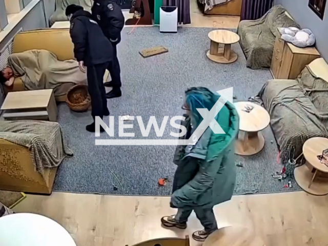 Police wake up a guy sleeping on a sofa in a cat café in Lipetsk, Russia on Monday, Oct. 30, 2023. He broke the window of café, cats ran away and hid. Note: Picture is screenshot from a video. (Newsflash)