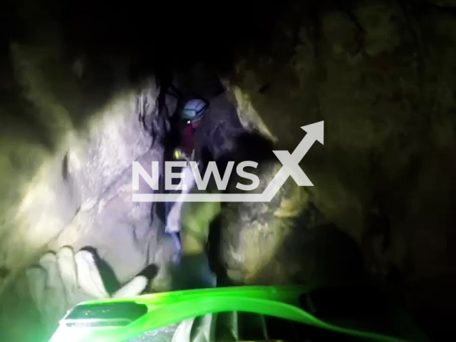 The slenderest rescuers move in narrow cave to evacuate a man stuck in Devil's Hole cave, Sochi, Russia on Monday, Nov. 6, 2023. The 43-year-old speleologist and a woman went to explore Devil's Hole, but only the woman climbed back and called the rescuers. Note: Picture is screenshot from a video. (@urpso_mchs/Newsflash)