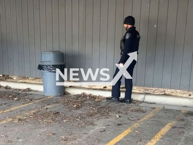 A police officer from the Auburn Hills Police Department, in Michigan, rescued a raccoon from a trash can, on 18th April. Note: Picture is a screenshot from a video (@AuburnHillsPolice/Newsflash)