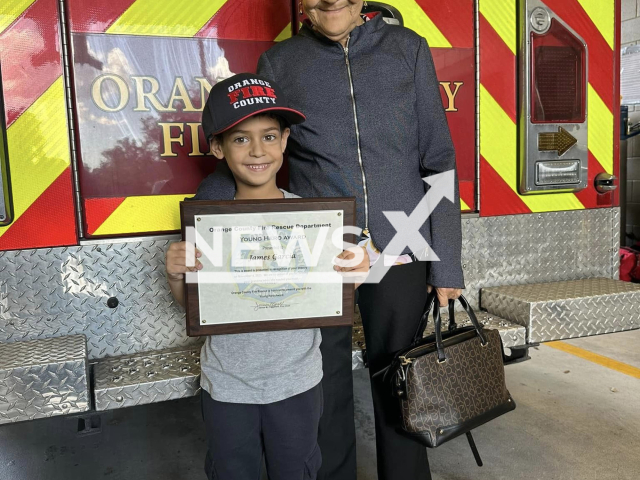 James Garcia poses with his grandmother Rosa Garcia in undated photo. He saved her life in Florida, US. Note: Fire department photo. (@OCFireRescue/Newsflash)