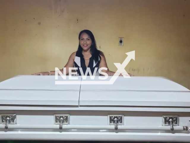 Jucykelly Ventura, 37,  poses with coffin, undated.  After being fired, she  received a luxury coffin worth BRL 10 thousand (GBP 1,616) as workers' compensation, in Monteiro, Brazil. Note: Private photo. (Newsflash)