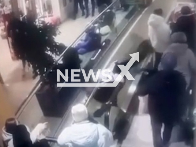 A teenager falls downstairs while using an escalator in Tomsk, Russia, undated. The teenager survived the fall. Note: Picture is screenshot from a video. (Newsflash)