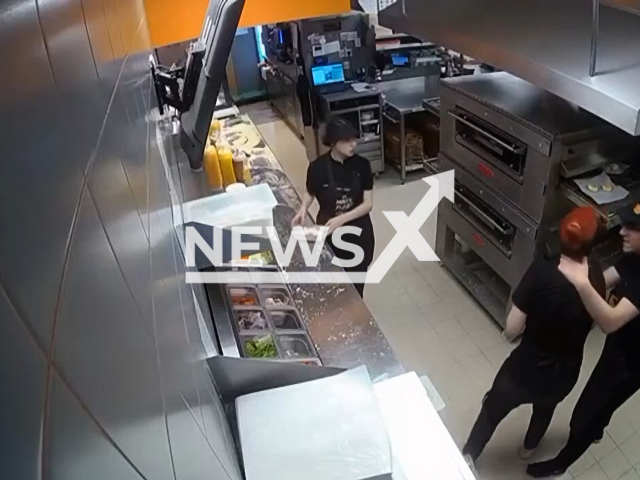 An employee of pizzeria beats up his colleague in the kitchen in Tikhvin, Leningrad Oblast, Russia, undated. He strangled and hit her head on the stove.Note: Picture is screenshot from a video. (Newsflash)