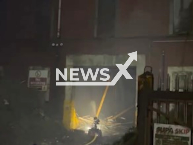 Firefighters are continuing to extinguish the fire using a new robot in a building which contains over 13,000 tonnes of compacted waste, in Lancaster, UK. 
Note: Picture is screenshot from a video. (Lancashire Fire and Rescue Service/Clipzilla)