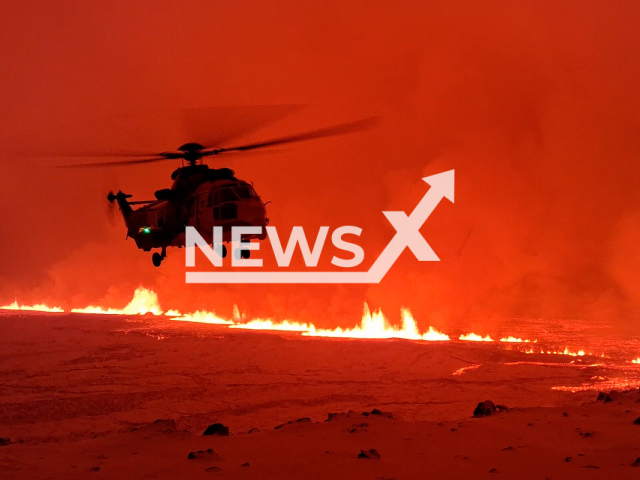 Coast Guard helicopter flies over a volcanic eruption north of Grindavik, Iceland, onTuesday, Dec 19, 2023. The helicopter crew was called out to fly with three scientists so that the extent of the eruption, the length of the fissure and the flow of lava could be assessed. Note: Picture is screenshot from a video. (Icelandic Coast Guard/Newsflash)