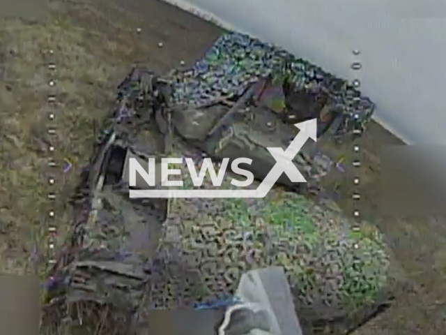 Russian soldiers jump in panic after their armoured vehicle is targeted by a Ukrainian kamikaze drone in Zaporizhzhia Oblast in Ukraine in undated footage. The footage was released by the Military unit 3017 of the National Guard of Ukraine on Wednesday, Dec. 20, 2023.Note: Picture is screenshot from a video. (@ngu3017/Newsflash)