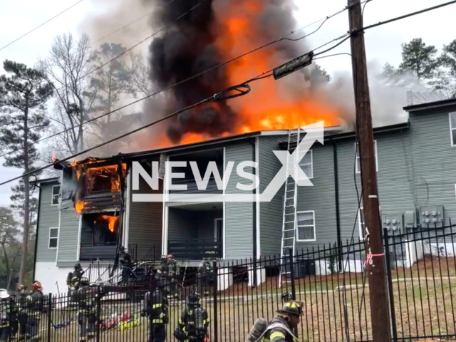 Firefighters working to contain an apartment building in Colombia, South Carolina, USA, on Tuesday, Jan. 23, 2024. Note: Picture is a screenshot from the video. (Columbia-Richland Fire Department/Clipzilla)