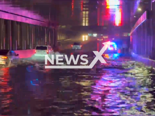 Cars pass trough flooded overpass, in Lufkin, Texas, USA. Note: Picture is a screenshot from the video. (Lufkin Police Department/Clipzilla)