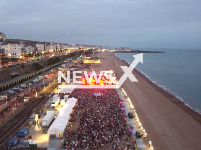 Drone operator Giles Dalby, 39, loses control of the drone and it crashes into a stage at a concert, in Brighton, UK. Note: Picture is a screenshot from the video. (Sussex Police/Clipzilla)