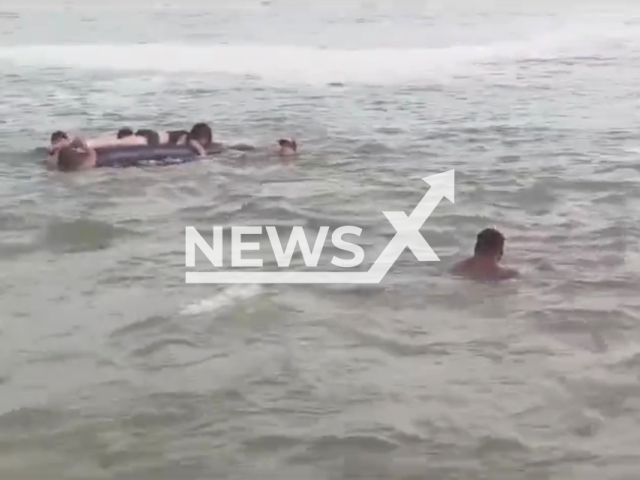 Police rescue two minors who were dragged out to sea on Arenilla beach, in Peru, in January, 2024. Note: Picture is a screenshot from the video.(@PoliciaPeru/Clipzilla)