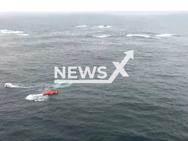 The coast guard recues three crew members of a fishing boat off the coast of Porto do Son, Spain. Note: Picture is a screenshot from the video. (	
Salvamento Maritimo/Clipzilla)