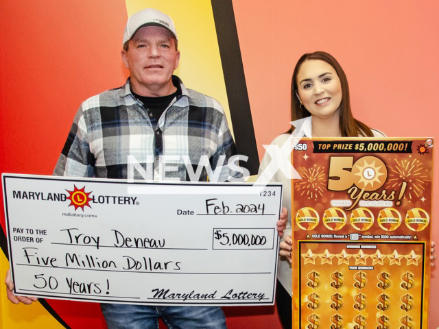 Troy Deneau and his wife Rachel of Dorchester County, MD pose for a photo after he won the second of three $5 million top prizes on the 50 Years! scratch-off, undated. Note: Lottery photo. (Maryland Lottery/Newsflash)