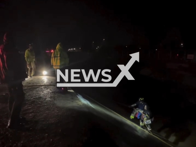 A woman is removed from a flood control channel in Escondido, California, USA, on Tuesday, Feb. 6, 2024. Note: Picture is a screenshot from the video. (Escondido Police Department/Clipzilla)