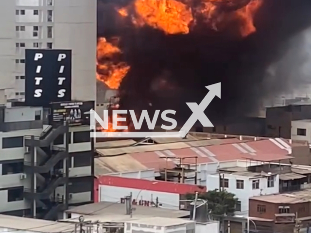 A fire at chemical supplies warehouse in Lima, Peru, on Monday, Feb. 12, 2024. Note: Picture is a screenshot from the video. (National Emergency Operations Center/Clipzilla)