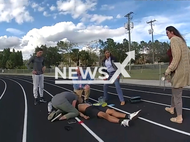 Deputy Biland helps a student that collapsed during track practice at Leto High School, in Hillsborough County, Florida, USA, on Monday, Feb. 5, 2024. Note: Picture is a screenshot from the video. (Hillsborough County Sheriff's Office/Clipzilla)