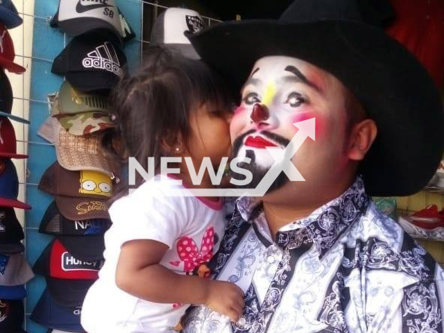 Leonel Agudo Mora known as the clown 'Pistachon' poses with a child in undated photo. He  was sentenced to 235 years for killing his two daughters in Oaxaca, Mexico. Note: Private photo. (Newsflash)