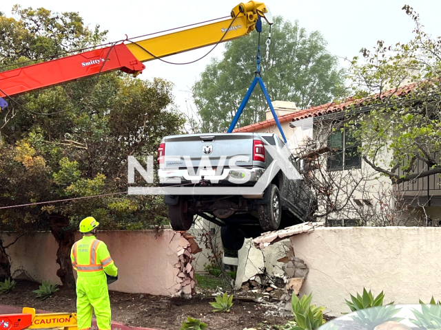 Firefighters remove the vehicle from the house, in Montecito, California, USA, on Friday, Feb. 16, 2024.   A driver suffered a medical emergency and subsequently drove through a wall and into a bedroom. Note: Photo from fire department. (Montecito Fire/Clipzilla)