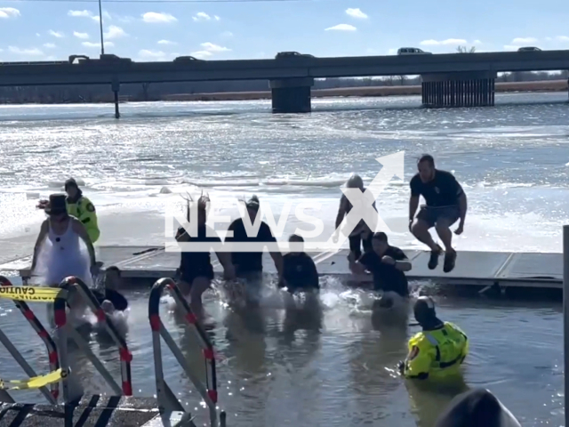 Madison Police Department do a Polar Plunge, in Madison, Wisconsin, USA. Note: Picture is a screenshot from the video. (Madison Police Department/Clipzilla)