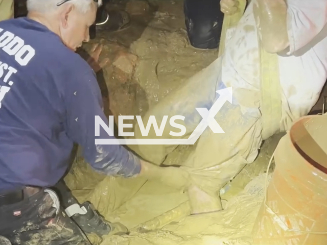 Firefighters recue a man trapped in some very thick mud in Caddo , Louisiana, USA, on Friday, Feb. 23, 2024.  Note: Picture is a screenshot from the video. (Caddo Fire District #4/Clipzilla)