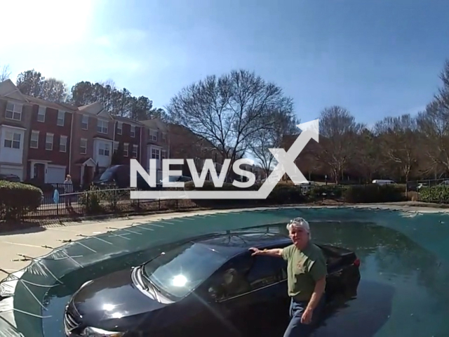 Police recue sinking driver after crashing into swimming pool in Cobb County, Georgia, USA, on Feb. 21, 2024.Note: Picture is screenshot from a video. (Cobb County Police Department/Clipzilla)