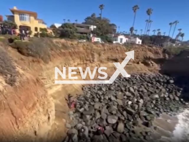 The rescue of a woman in her 20's fell from the street level to the rocks below in a about a 25 foot drop in San Diego, California, USA, on Saturday, March 2, 2024.Note: Picture is screenshot from a video. (San Diego Fire-Rescue Department)