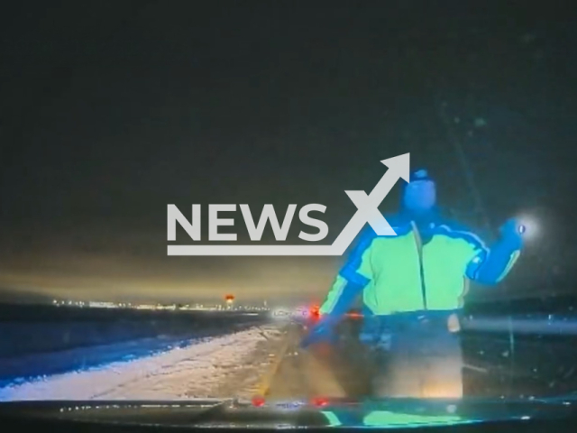 Trooper Rowley signals an inattentive semi-driver who has to swerve into the median to avoid hitting his vehicle on I-84 near Meridian, Idaho, USA. Note: Picture is a screenshot from the video. (Idaho State Police/Clipzilla)