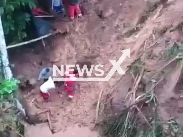 Members of the police, personnel from the Volunteer Firefighters and the district municipality carry out search and rescue work for a missing minor after the intense rains in the Santo Domingo de Anda district, Peru, on Thursday, March 7, 2024.Note: Picture is screenshot from a video. (Centro de Operaciones de Emergencia Nacional/Clipzilla)