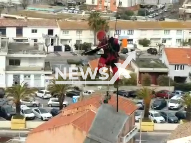 A member of the SMPM removes a cladding element of the lighthouse threatening to fall of damaged from bad weather, in Herault, France, on Sunday, March 10, 2024. Note: Picture is a screenshot from the video. (Sapeurs-Pompiers de l'Herault/Clipzilla)