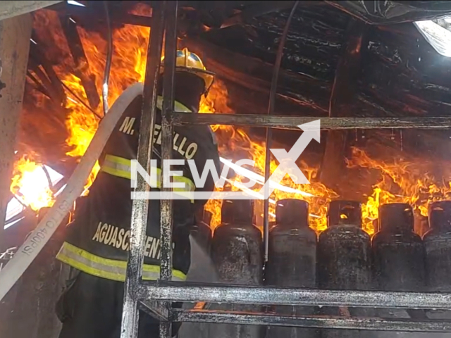 Firefighters put out fire in the fire of a filling platform inside the gas plant, where more than 1,000 tanks were burning in flames, in Aguascalientes, Mexico. Note: Picture is a screenshot from the video. (Proteccion Civil Municipal AGS/Clipzilla)