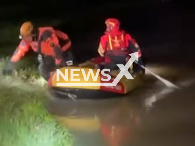 Firefighters recover  Mia  a sheepdog who swam across the river, becoming stuck on the other bank  due to current, in Vicenza, Italy, on  Monday, March 11, 2024. Note: Picture is a screenshot from the video. (Interregional Fire Brigade Directorate of Veneto and Trentino Alto Adige/Clipzilla)