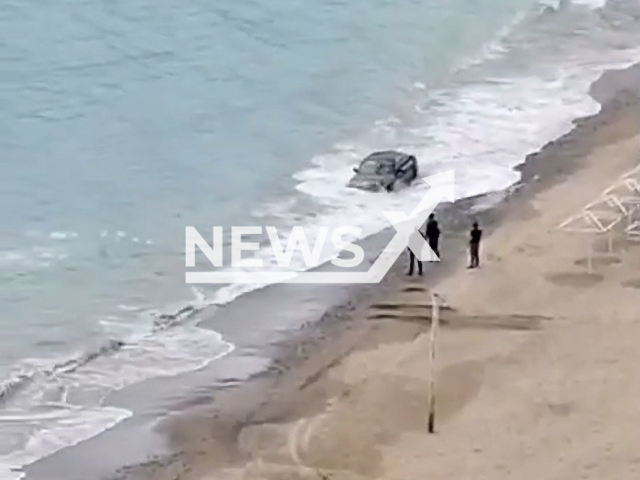 Footage shows men and a car on the beach of Black Sea in Dzhubga resort, Krasnodar Krai, Russia, undated. Men tried to make photos but car stuck in the water.Note: Picture is screenshot from a video. (Newsflash)