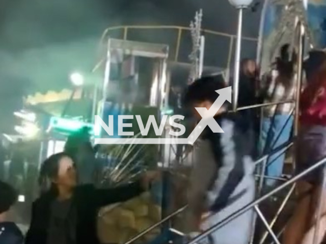 People run to escape as toy catches fire at amusement park in Praia Grande, Brazil, Saturday, June 1, 2024. Nobody was injured. Note: Picture is screenshot from a video. (Newsflash)