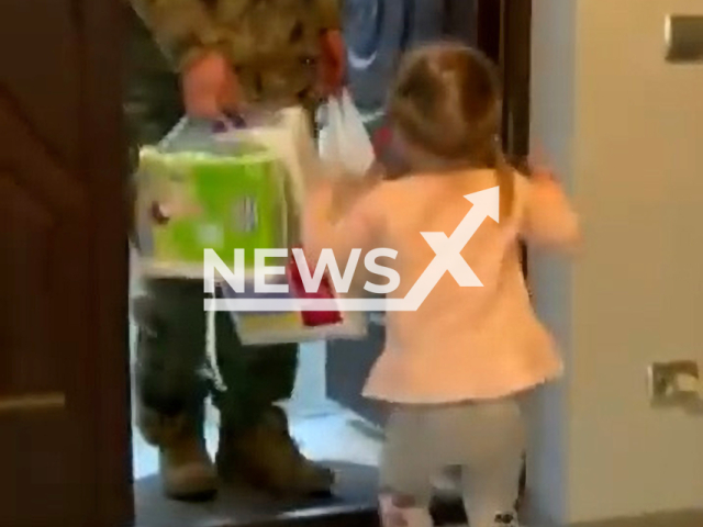 A little girl sees her father, a solder in the Ukrainian Army at home, in April, 2022. Note: This picture is a screenshot from the video (National Guard of Ukraine/Newsflash).