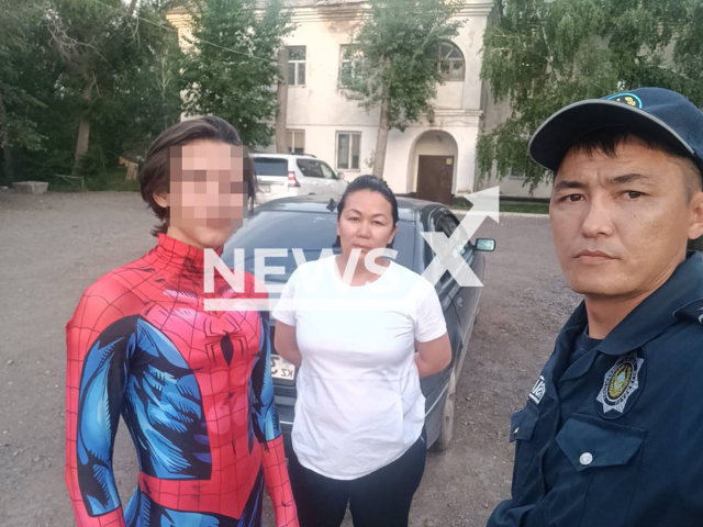 Footage shows a teenager, 16, in a costume of Spiderman, his mother and police officer Dastan Zhakpanov in Semey, in eastern Kazakhstan, undated. The teenager climbed heating pipes. Note: Photo is obtained from the Ministry of Internal Affairs of the Republic of Kazakhstan. (@POLICE_of_KZ/Newsflash)