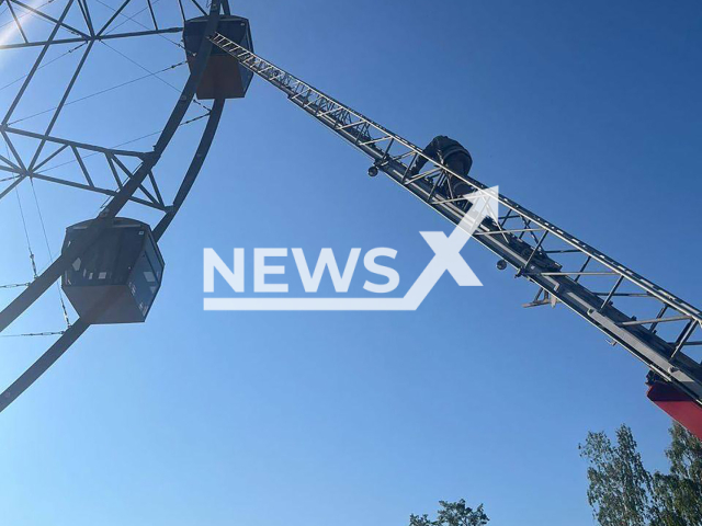 Footage shows a stuck Ferris wheel and an emergency crane in a city park of Neftekamsk, Russia on Sunday, June 16, 2024. As result, six people were rescued from the wheel. Note: Photo is obtained from the Ministry of Emergency Situations of the Russian Federation. (@mchs_official/Newsflash)