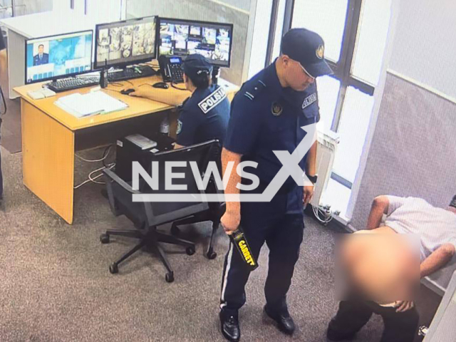 Man exposes his buttocks and shows them to the police officer at government office in Astana, Kazakhstan on Thursday, June 27, 2024. The man was fined. Note: Private photo taken from local media. (Newsflash)