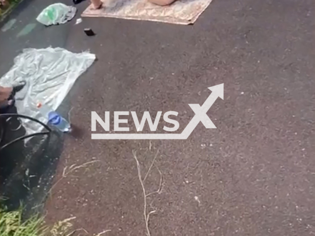 A man with half naked buttocks sunbathes on the children playground in Moscow, Russia, undated. He attacked a woman who asked him to get dressed and leave.Note: Photo is a screenshot from a video. (Newsflash)