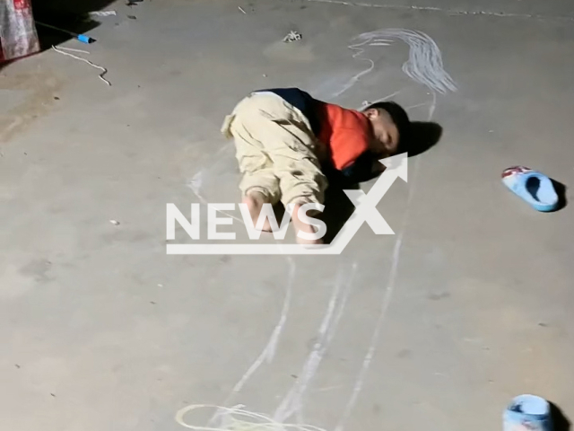 Cute baby lies on pregnant mom's drawing in Qingdao, China. Note: This picture is a screenshot from the video (hh201972566/AsiaWire).