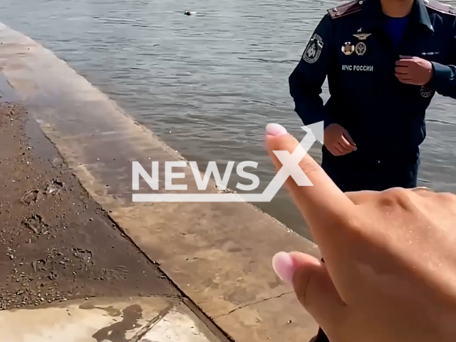 Footage shows emergency worker during filming official video near river in Ufa, Russia on Saturday, July 6, 2024. A drowned body was allegedly floating in the river.  Note: Photo is a screenshot from a video. (@mchs_official/Newsflash)