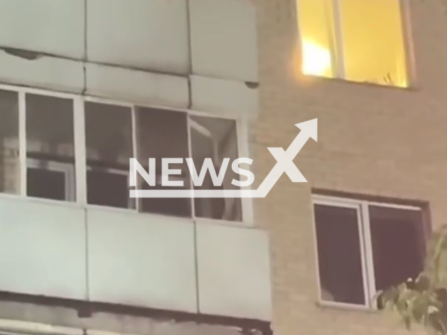 Footage shows a woman being rescued from burning apartment in Astana, Kazakhstan on Wednesday, July 10, 2024. When the woman was hanging from a balcony, a man caught her. Note: Picture is screenshot from a video (@tjd_astana/Newsflash)