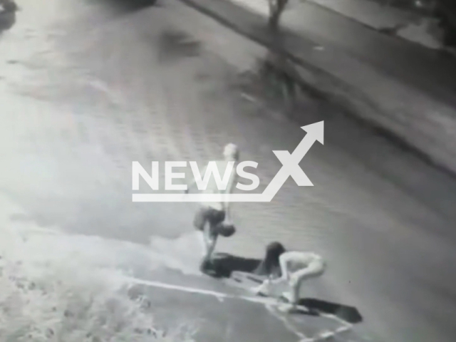 A couple picks up stones and throws them at a driver, who drives the vehicle towards the couple and hits them in Contagem, Brazil, on 2nd May. Note: Picture is a screenshot from a video (Newsflash)