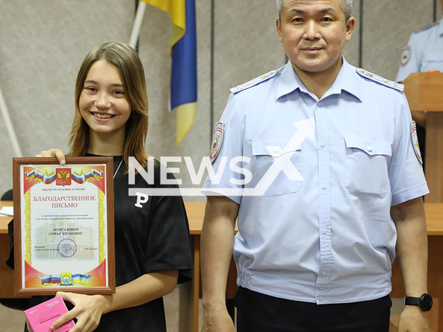 Photo shows a police officer and schoolgirl Sofia Mungalova (left), a friend of Kirill Safonov, 17, from Ulan-Ude, Buryatia, Russia, undated. She was awarded for helping to catch Kirill's alleged murderer. Note: Photo is obtained from the Ministry of Internal Affairs of Buryatia. (@mvd_03/Newsflash)