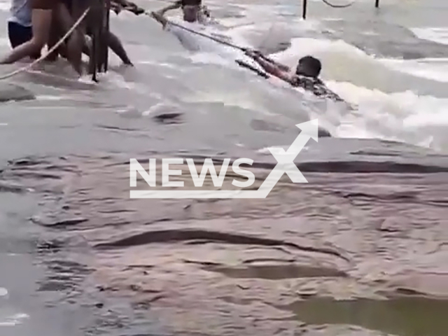 A guy loses his grip on the rope and is carried away by the water in the waterfall in Chittorgarh, Rajasthan, India on Monday, Aug. 5, 2024. He allegedly wanted to make a selfie video.Note: Photo is a screenshot from a video. (Newsflash)