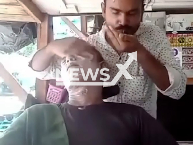 Salon worker uses his spit to massage client in Kannauj, India, undated. The police are investigating the case.Note: Photo is a screenshot from a video. (Newsflash)